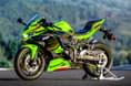 The ZX4RR comes in a special Kawasaki Lime Green colour, compared to the base 4R which only comes in black. Kawasaki Ninja ZX4RR front left static image on track